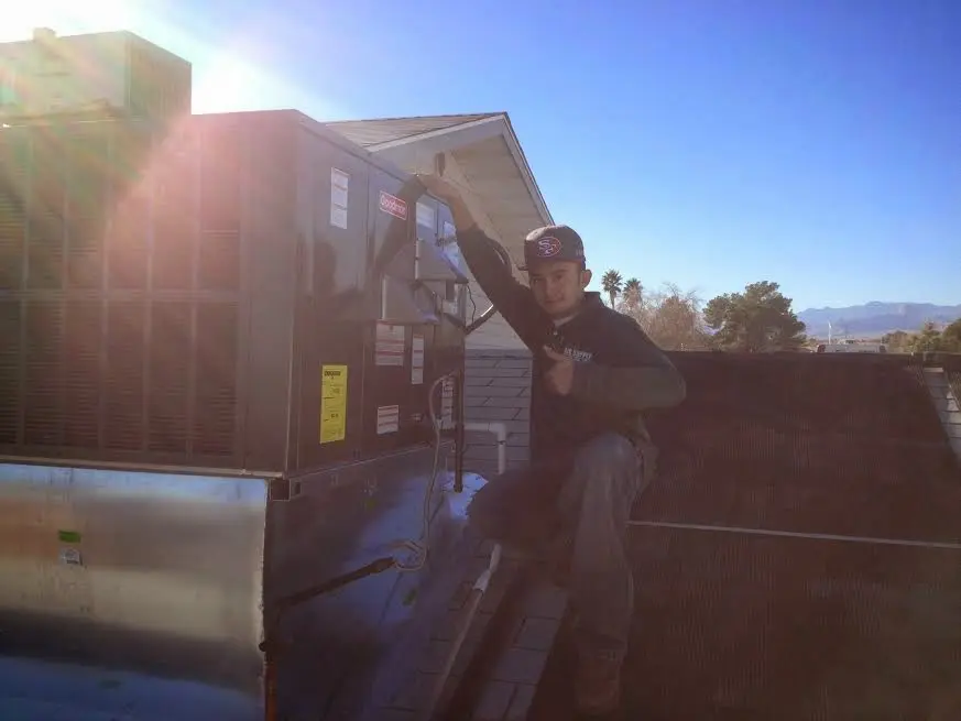 HVAC technician performing HVAC Inspection on a rooftop unit in Spotsylvania Courthouse